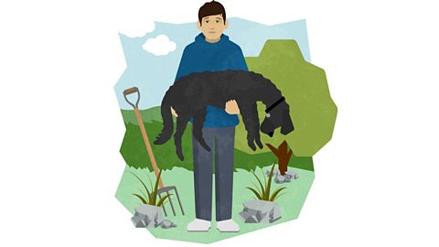 Christopher wearing a blue hoodie. He is holding a large, black poodle. There is a garden fork stuck into the grass next to him