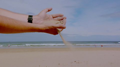 Sand pouring out of hand