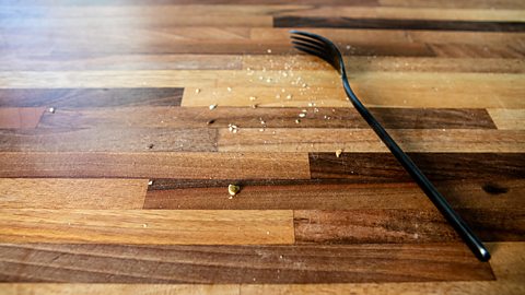fork and crumbs on a kitchen counter