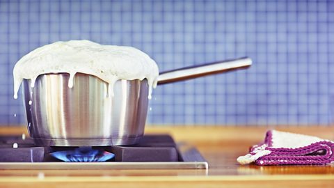 milk boiling over in a pan