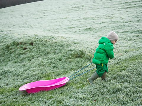 A child with a sledge.