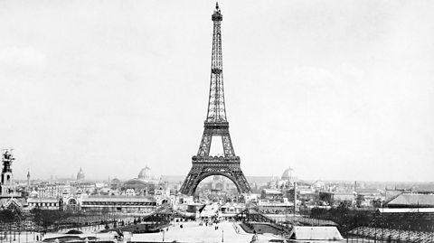 A black and white photograph taken in 1889 showing the Eiffel Tower and the rooftops of Paris