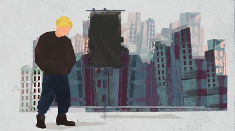 Callum is wearing dark clothes and standing with his hands in his pockets beside a black flag. There is a cityscape in the background.