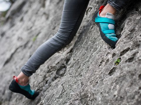 A woman rock climbing.