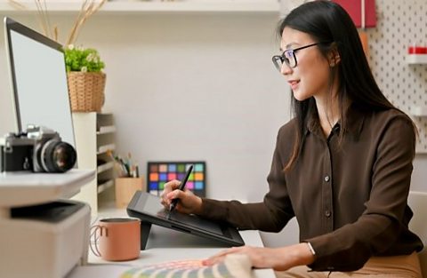 A person works on a tablet.