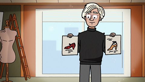 Andy Warhol is holding two shoe designs