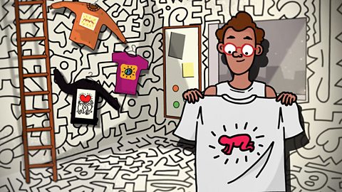 Keith Haring is in his pop shop holding a t-shirt with the design of a baby in pop art style