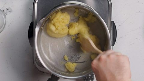 A film forms on the bottom of the pan while the choux pastry cooks on the hob