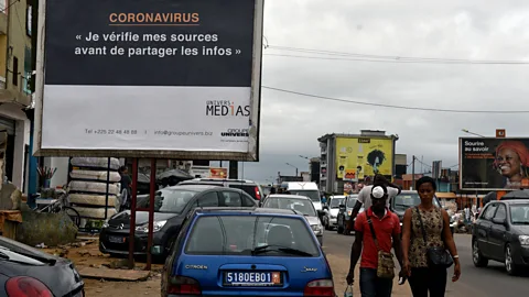 Sia Kambou/Getty Images A sign in Abidjan, Ivory Coast, urges the public to check their sources before sharing information about Covid-19 (Credit: Sia Kambou/Getty Images)