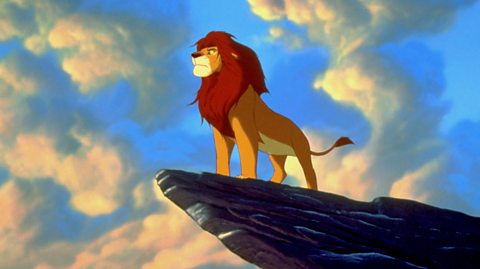 Simba, the main lion character from Disney's The Lion King, overlooks the horizon from a cliff.