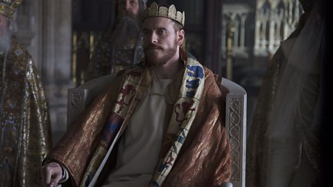 Macbeth (Michael Fassbender) sits on a throne after being crowned king. Scene from the film Macbeth (2015)