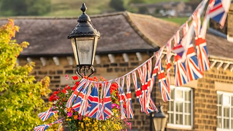 Union Jack flags hang above a street 