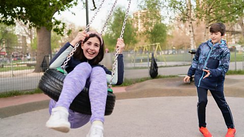 Children take time away from their screens to play in a playground