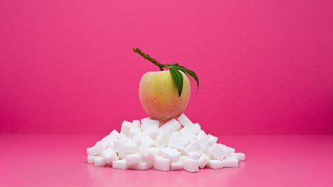 An apple sitting on top of sugar