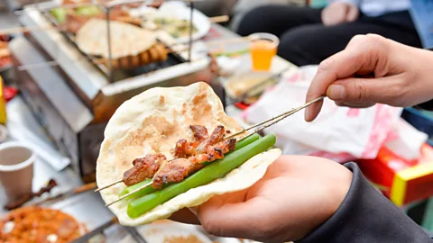 VCG/VCG via Getty Images Zibo barbecue is unique in China in that the grilled meat is eaten in a wrap with condiments (Credit: VCG/VCG via Getty Images)