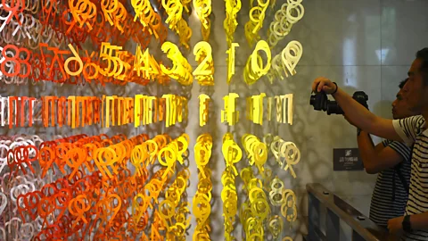 Getty Images Visitors take pictures of an art installation named 100 colours by French architect Emmanuelle Moureaux (Credit: Getty Images)