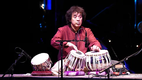 Getty Images Zakir Hussain describes using each finger as a syllable when playing the twin hand drums of the tabla (Credit: Getty Images)