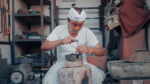 Quantum Temple Jro Mangku I Wayan Sudiarta is one of the last blacksmiths in Bali to make temple bells by hand (Credit: Quantum Temple)