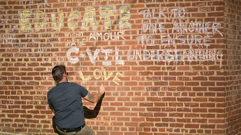 Getty Images Messages on a wall calling for compassion after violence at the Unite the Right rally in 2017 (Credit: Getty Images)