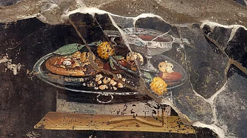 Abaca Press/Alamy A recently discovered fresco of a flatbread at Pompeii (Credit: Abaca Press/Alamy)