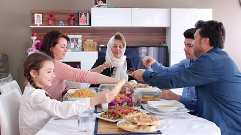 Family iftar meal in Ramadan, around a dining table.