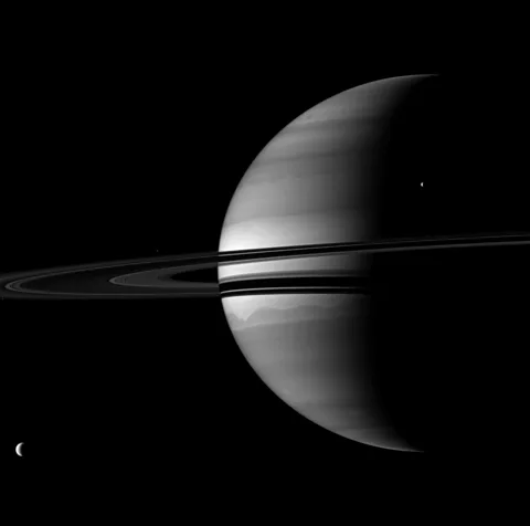 NASA/JPL/Space Science Institute Some of Saturn's moons are thought to have formed from material in the planet's rings colliding and clumping together (Credit: NASA/JPL/Space Science Institute)