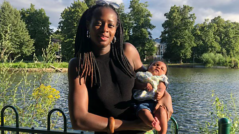 Latifat and her daughter Yazmin in the park, Yazmin is a small baby in the picture.