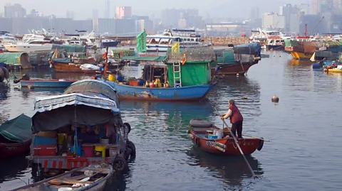 Doug Houghton/Alamy A woman rows a sampan boat in Hong Kong's Causeway Bay (Credit: Doug Houghton/Alamy)