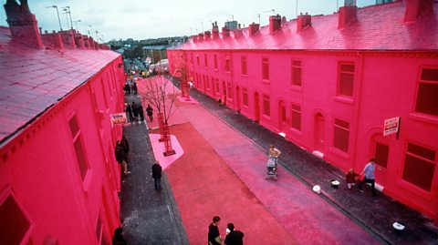 Rows of houses in Ash Street, Salford, painted bright pink.