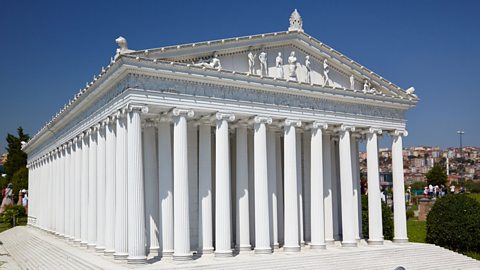 A white temple with ancient greek pillars.