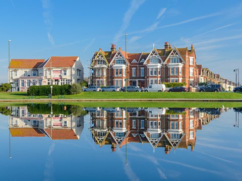 A house reflected in still water.