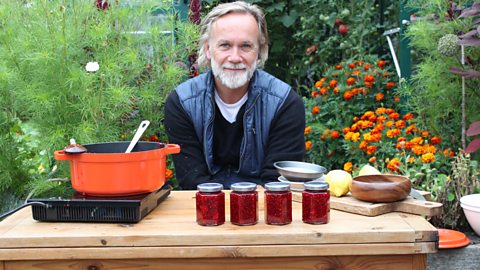 Marcus Wareing sitting with jars of homemade jam