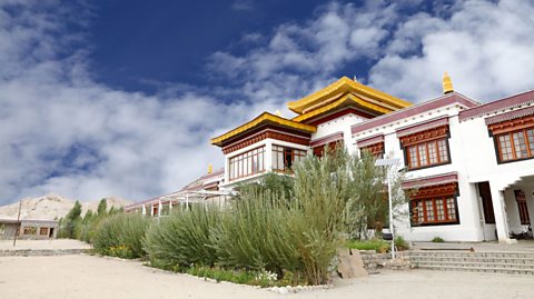 A white, red and yellow building with pagodas.