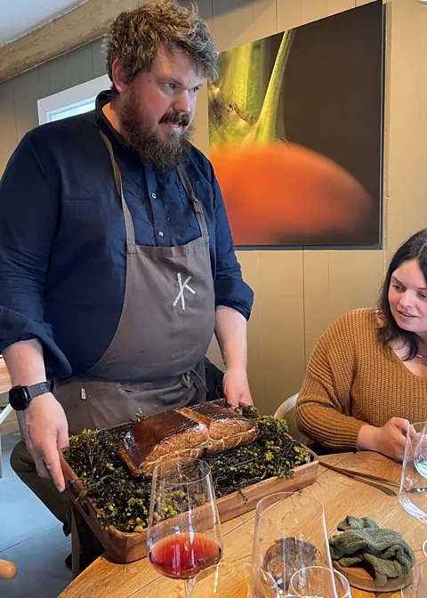 Molly Harris Halvar Ellingsen presents wood-smoked salmon at the table (Credit: Molly Harris)