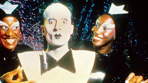 Alamy Performance artist and singer Klaus Nomi in his famous black-and-white suit with two backing performers