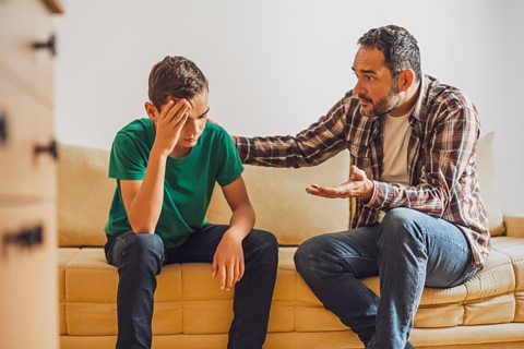 A father gestures when talking about his son's poor exam results