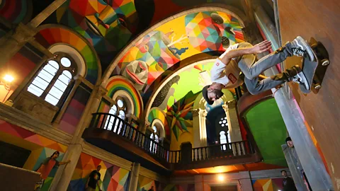 Getty Images Skateboarder skates on ramp in brightly coloured church interior