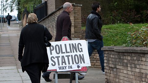 People entering a polling station.