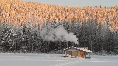 Fredrik Broman The sauna floats on the surface of the lake in summer and is frozen in place during winter (Credit: Fredrik Broman)