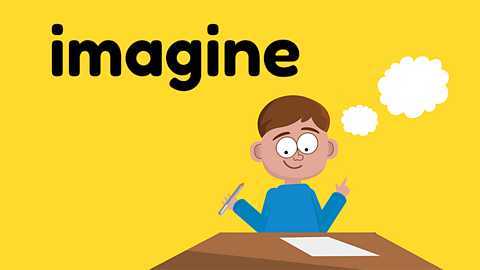 A child sat at a desk to write a story, seated beneath the word 'imagine'