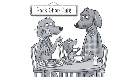 Three dogs sat at a table in the Pork Chop cafe.