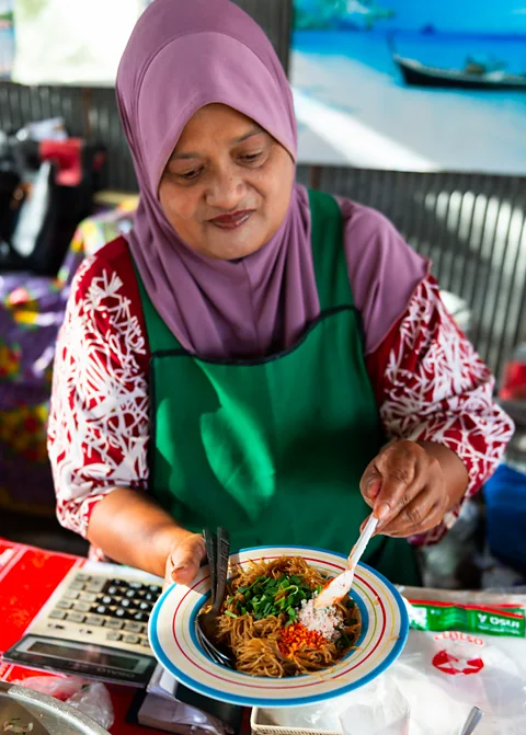 Austin Bush Ma Ya makes mii kathi and other dishes at her island shack (Credit: Austin Bush)