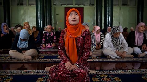 Female Imam Yonghua Zheng sat with rows of women behind her as she leads prayer.