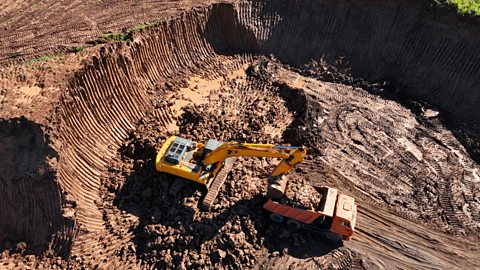 Excavator during clay mining mining in open pit