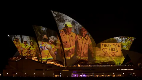 Brook Mitchell/Getty Image After the 'Black Summer' bushfires of 2020, the tired faces of firefighters who had battled the flames were projected onto it (Credit: Brook Mitchell/Getty Image)