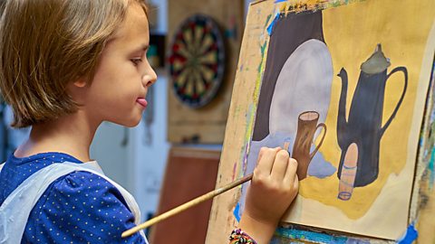 Girl painting a still life.