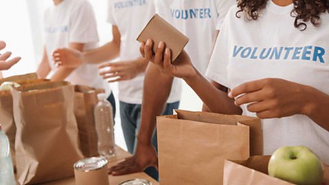 Volunteers packing food donation bags