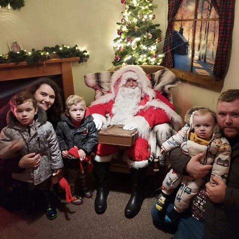 Corrine and Luke with their children and a visit from Santa.