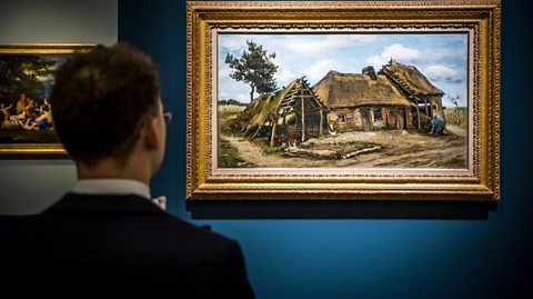 A shot of a man from behind looking at Vincent van Gogh's Peasant Woman in front of a Farmhouse. The painting is in a gold frame on a blue wall.