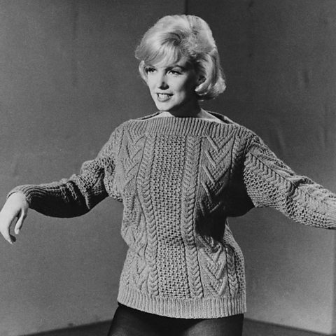 Hollywood actress Marylin Monroe wearing a thick, cable-knit jumper